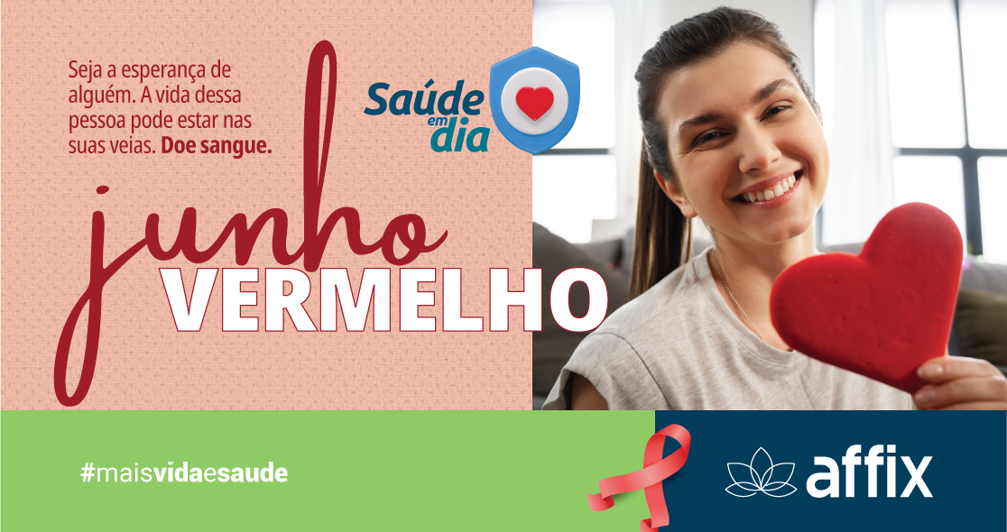 Imagem de blog da campanha Junho Vermelho da Affix. Mulher sorridente segura um coração vermelho. Texto: "Seja a esperança de alguém. A vida dessa pessoa pode estar nas suas veias. Doe sangue. Junho Vermelho." Logo Saúde em Dia no topo, e na parte